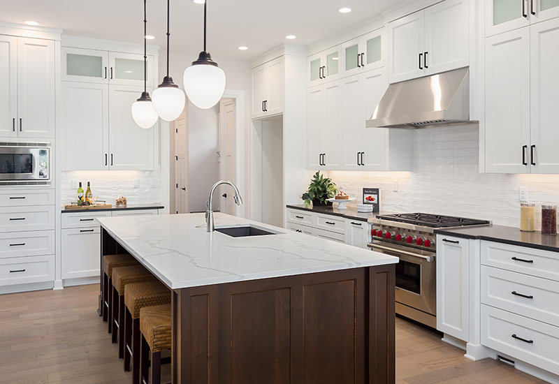 A large white kitchen with custom built cabinets in Portland, OR