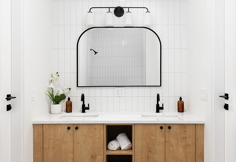 A vanity and mirror in a newly upgraded bathroom
